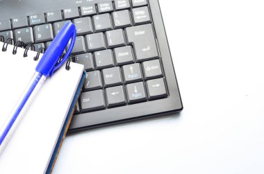 A notepad and keyboard of a computer. write down and save clipart