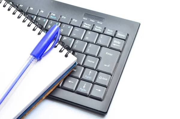 A notepad and keyboard of a computer. write down and save — Stock Photo, Image