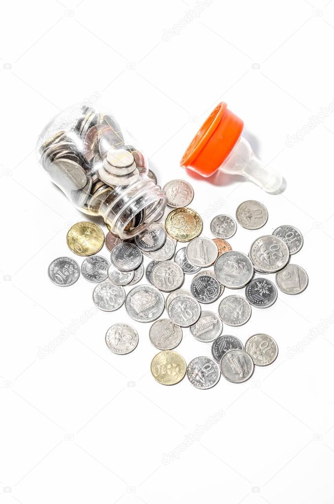 Malaysia Coins in Baby Bottle Conceptual Image to Represent the Cost of Raising Children.