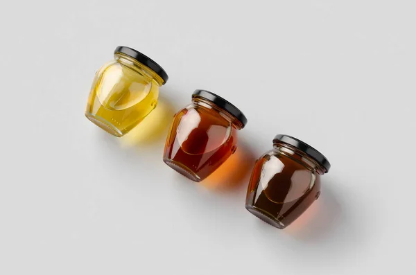 Honingpotten Model Een Grijze Achtergrond Drie Verschillende Kleuren — Stockfoto