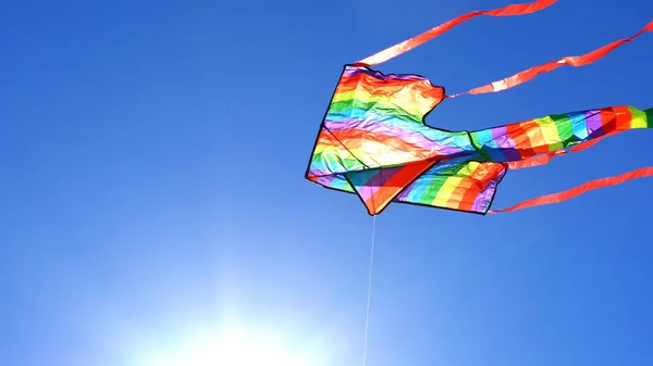 Colorful rainbow kite flying — Stock Photo, Image