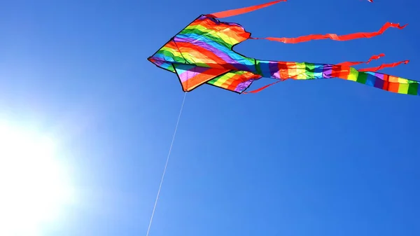 Colorful rainbow kite flying — Stock Photo, Image