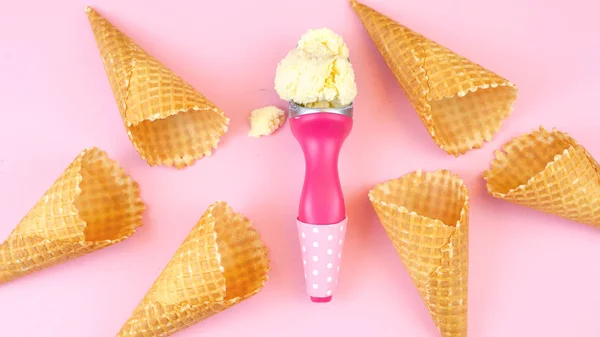 Ice cream cones and scoop overhead flat lay on pink wood. — Stock Photo, Image