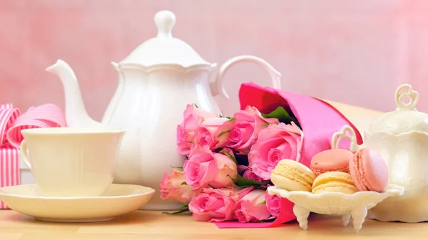 Μητέρες ημέρα ρύθμιση τσαγιού με τσαγιέρα, macaron μπισκότα, ροζ τριαντάφυλλα και δώρο. — Φωτογραφία Αρχείου