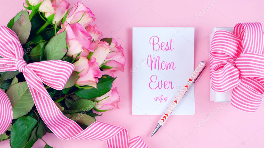 Mothers Day overhead with roses, Best Mom Ever card and gift on pink table.