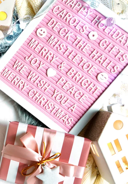 Christmas flat lay wrapping gifts with warm sweater, snacks and letter board. — Stock Photo, Image