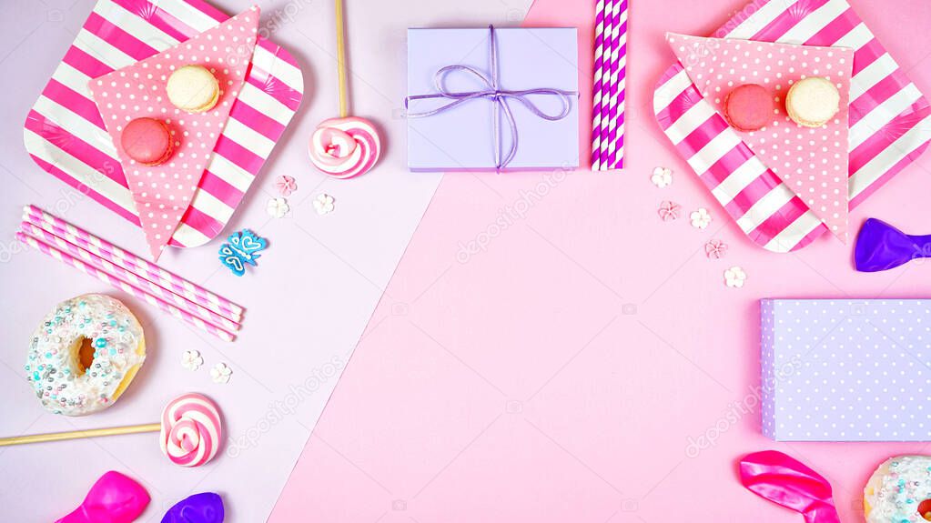 Colorful pink theme party food and decorations flat lay.
