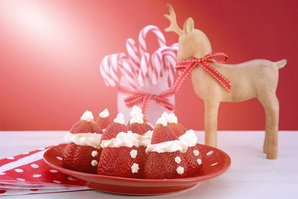 Christmas treats party food Strawberry Santas on red and white theme table. — Stock Photo, Image