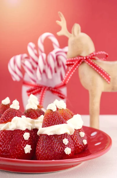 Natal trata comida de festa Morango Santas na mesa de tema vermelho e branco . — Fotografia de Stock