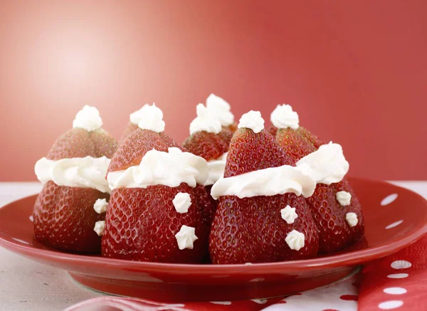 Christmas treats party food Strawberry Santas on red and white theme table. — Stock Photo, Image