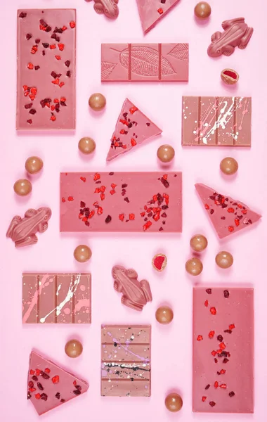 Ruby chocolate selection flat lay overhead on pink background. — Stock Photo, Image