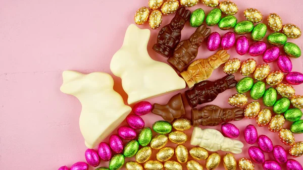 Easter flat lay of white, milk and dark chocolate and candy bunnies and eggs. — Stock Photo, Image