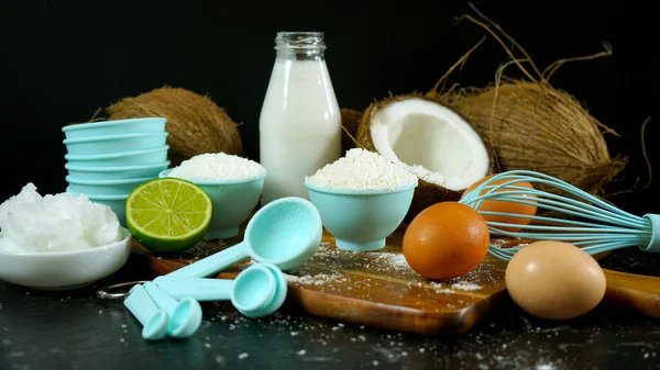 Coconut baking ingredients, coconut milk, flour, oil, and shredded coconut. — Stock Photo, Image