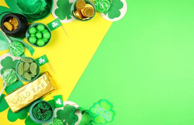 St Patricks Day flat lay with chocolate coins, leprechaun hat and shamrocks.