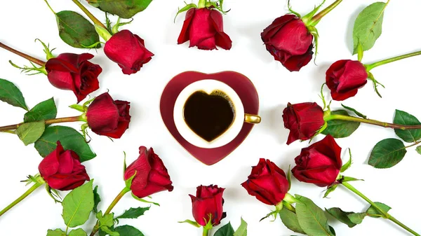 Red roses creative flat lay layout with coffee in heart shaped cup and saucer. — Stockfoto