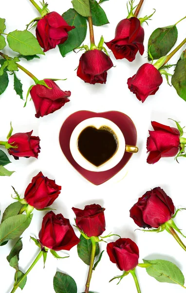 Red roses creative flat lay layout with coffee in heart shaped cup and saucer. — Zdjęcie stockowe