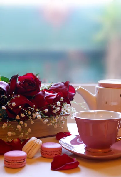 Relaxing by the window with old books and cup of tea. — Stockfoto