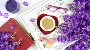 Vintage Springtime creative layout with lilac, coffee break with old books.