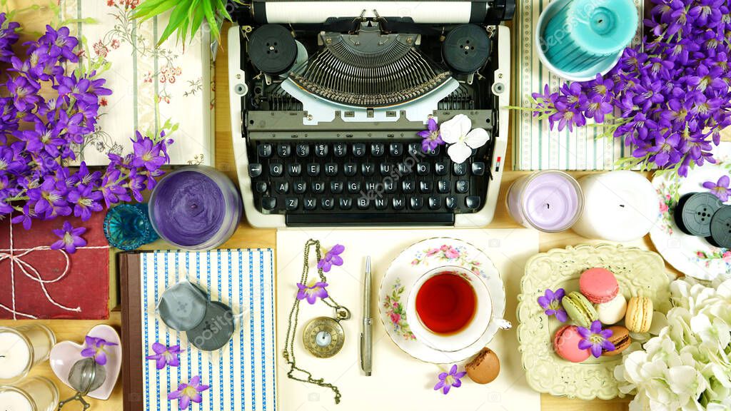 Vintage writers desk creative composition flat lay with typewriter and books.