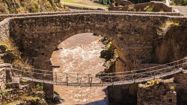 The colonial Checacupe bridge is located on the Ausangate or Pitumayu river, Cusco Peru clipart