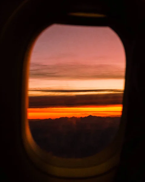 sunset in airplane window in flight