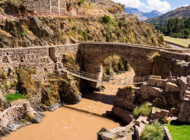 The colonial Checacupe bridge is located on the Ausangate or Pitumayu river, Cusco Peru clipart