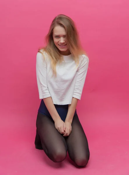 Girl in black tights dancing on a pink background — Stock Photo, Image