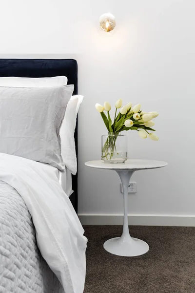 Close up of tulips on a bedside table — Stock Photo, Image