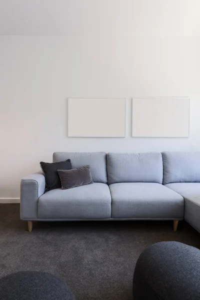 Pastel blue sofa with blank artwork above — Stock Photo, Image