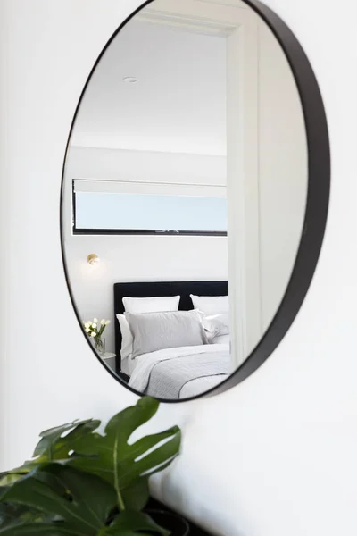 Bedroom reflected in a hallway mirror — Stock Photo, Image