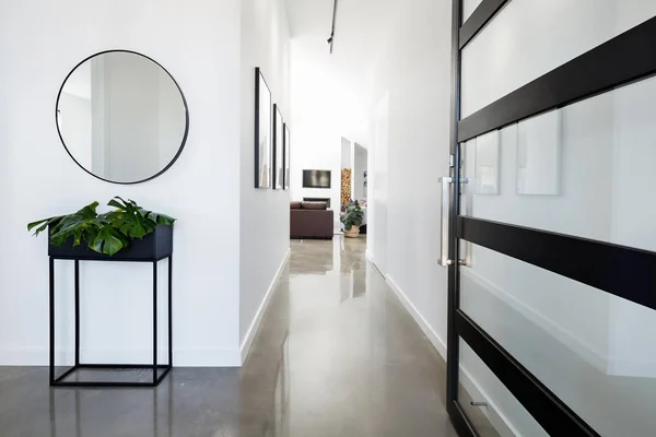 Contemporary home entry with polished concrete floors Stock Photo