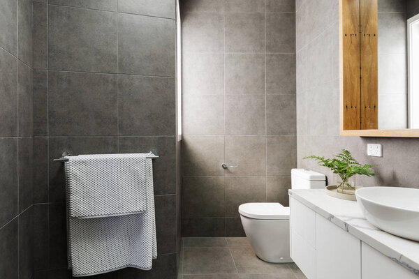 Charcoal grey bathroom with marble benctop Stock Photo