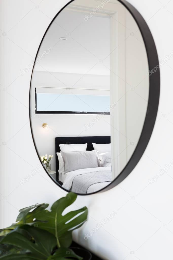 bedroom reflected in a hallway mirror