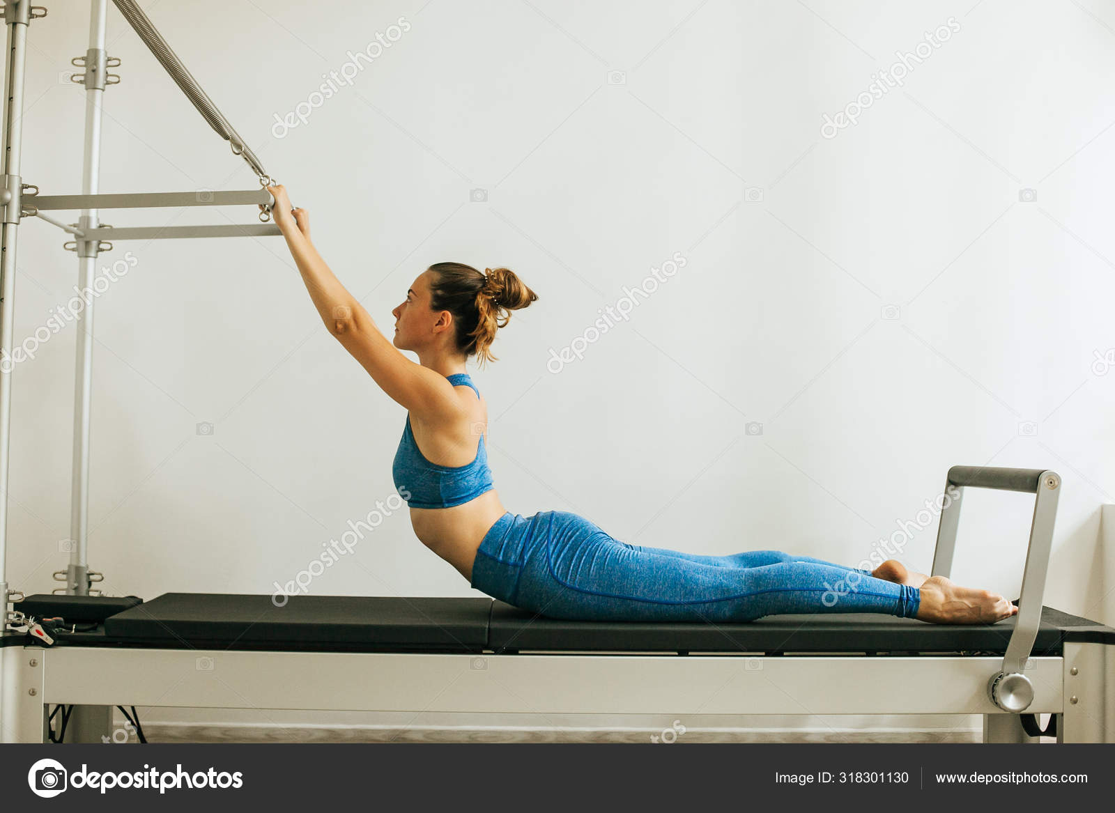 Woman Performing Pilates Exercise Using Cadillac Trapeze Table Stock Photo  by ©Merry_vk 318301130