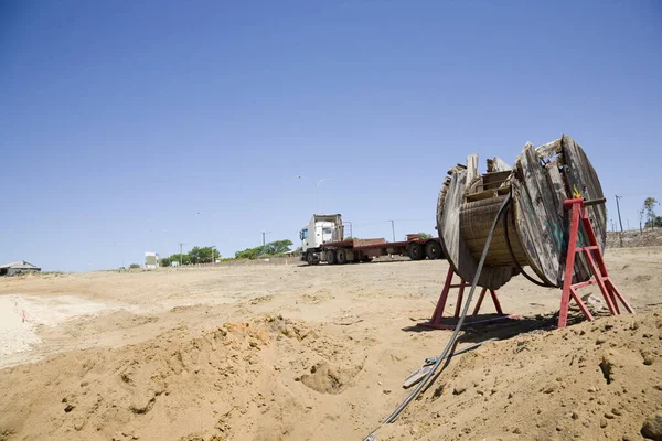 A cable drum set up in a new development, for underground power supply. — Stock Image Cable Drum Set New Development Underground Power Supply Stock Picture