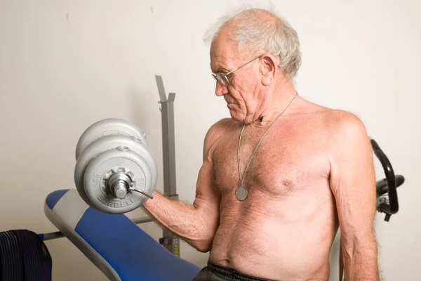 Senior Man Exercising using weights.