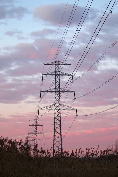 Hoogeveen, the Netherlands - December 30, 2019: electricity pylon at dawn in Oude Kene, the Netherlands