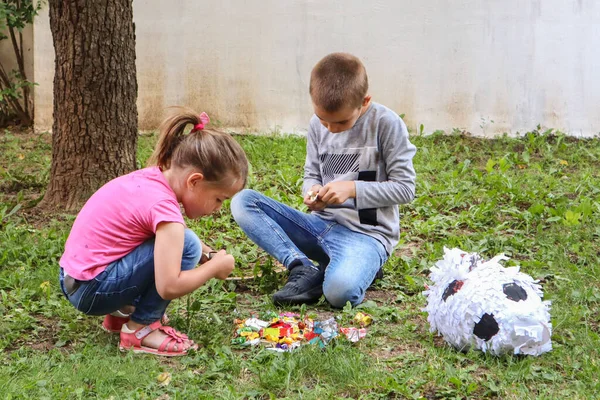 Two Children Eat Sweets Candy Ground Garden Broken Pinata Toy — Stock Photo, Image