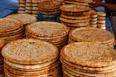 Traditional Uyghur flat bread on a market stall in Kashgar, China. clipart