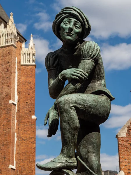 Cracow/Poland - 22/04/2020. Sculpture of poor student in the fountain at the Mariacki Square, Old Town.