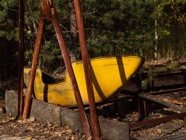 Abandoned amusement park in ghost town Pripyat. Overgrown trees and collapsing buildings in Pripyat, Chernobyl exclusion zone. Ukraine