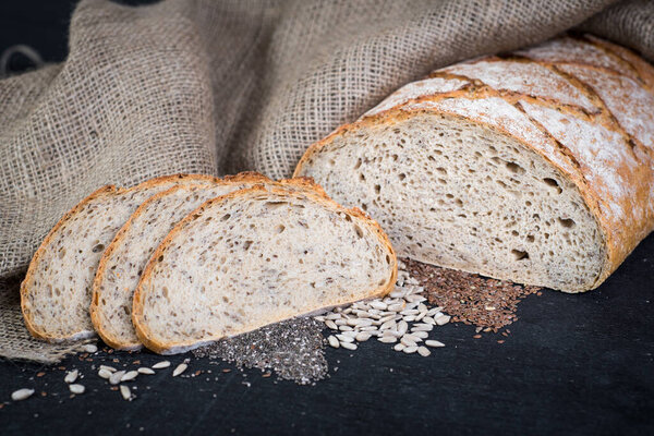 Dietic bread with nuts on wooden background