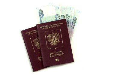 Two Russian passports with a pack of one thousand rubles. The concept of immigration, tourism, travel to the resort. Purchase or pledge, a large amount of rubles. Isolated on a white background.