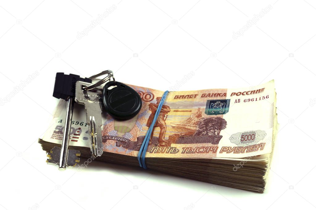 A pack of Russian rubles with a face value of five thousand rubles with the keys to the apartment. A pack of Russian money of large denominations of a million rubles. The concept of buying an apartment, mortgage, loan