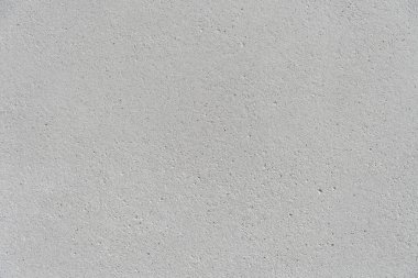 White concrete wall with a flat surface and small pores. Gray surface for design background texture.