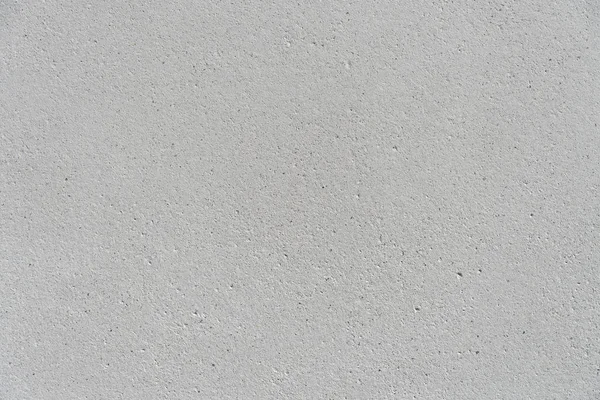 White concrete wall with a flat surface and small pores. Gray surface for design background texture. — Stockfoto