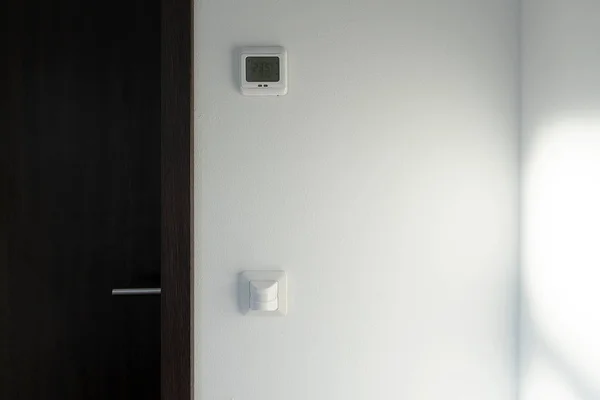 Smart home system. The room has a motion sensor to turn on the light. There is a climate control of the temperature in the room.