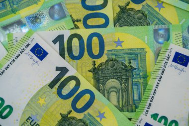 100 avroluk banknotlar kaotik bir şekilde dağıtıldı. Avrupa para birimi masada yatıyor. Yakın plan. Tasarım için boşluk, arka plan. Yukarıdan görüntüle.