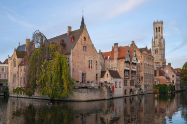 BRUGES, BELGIUM - NOVEMBER 3, 2019: Historic buildings of Bruges close to the canals on November 3, 2019 in Belgium