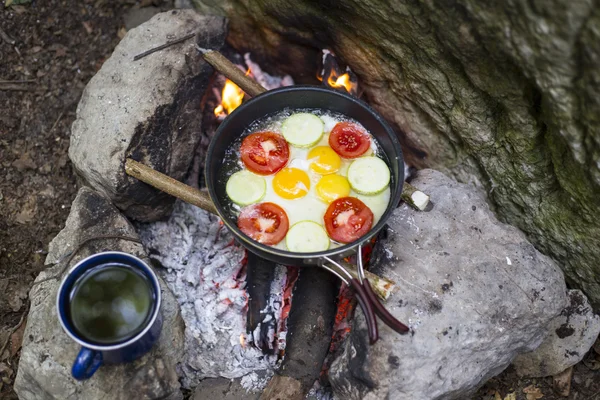 Cooking breakfast.Cooking breakfast on a campfire at a summer camp.